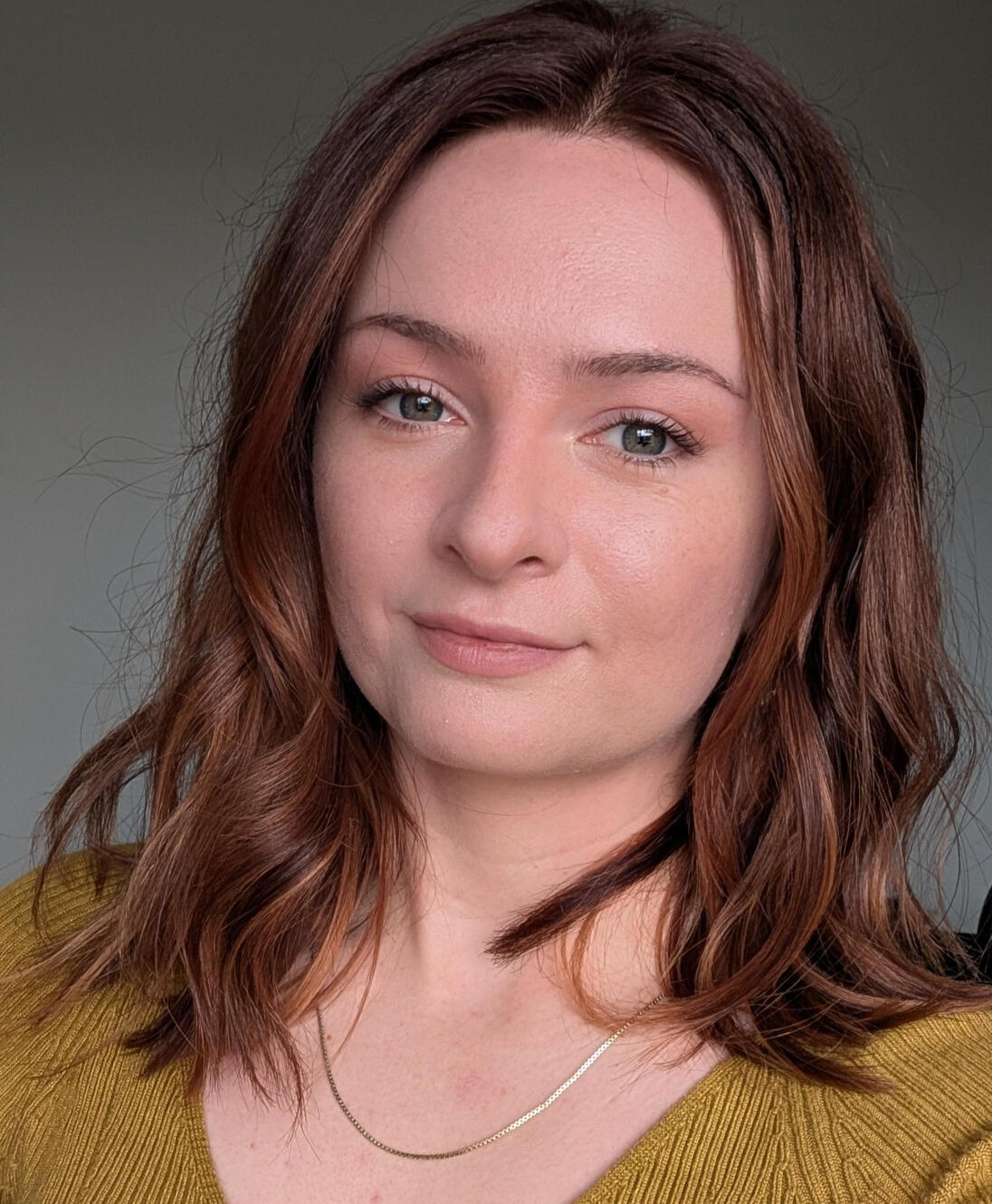 Vector illustration of woman lying down on her tummy, with a camera to take a photo of a puffin, but the puffin has climbed on top of the camera lens. The woman is looking at the puffin amazed.